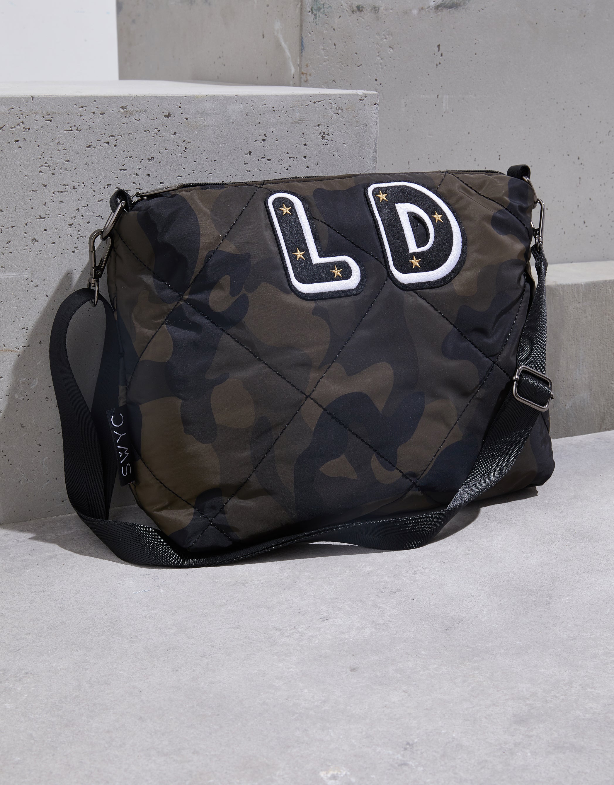 Camo print quilted messenger bag