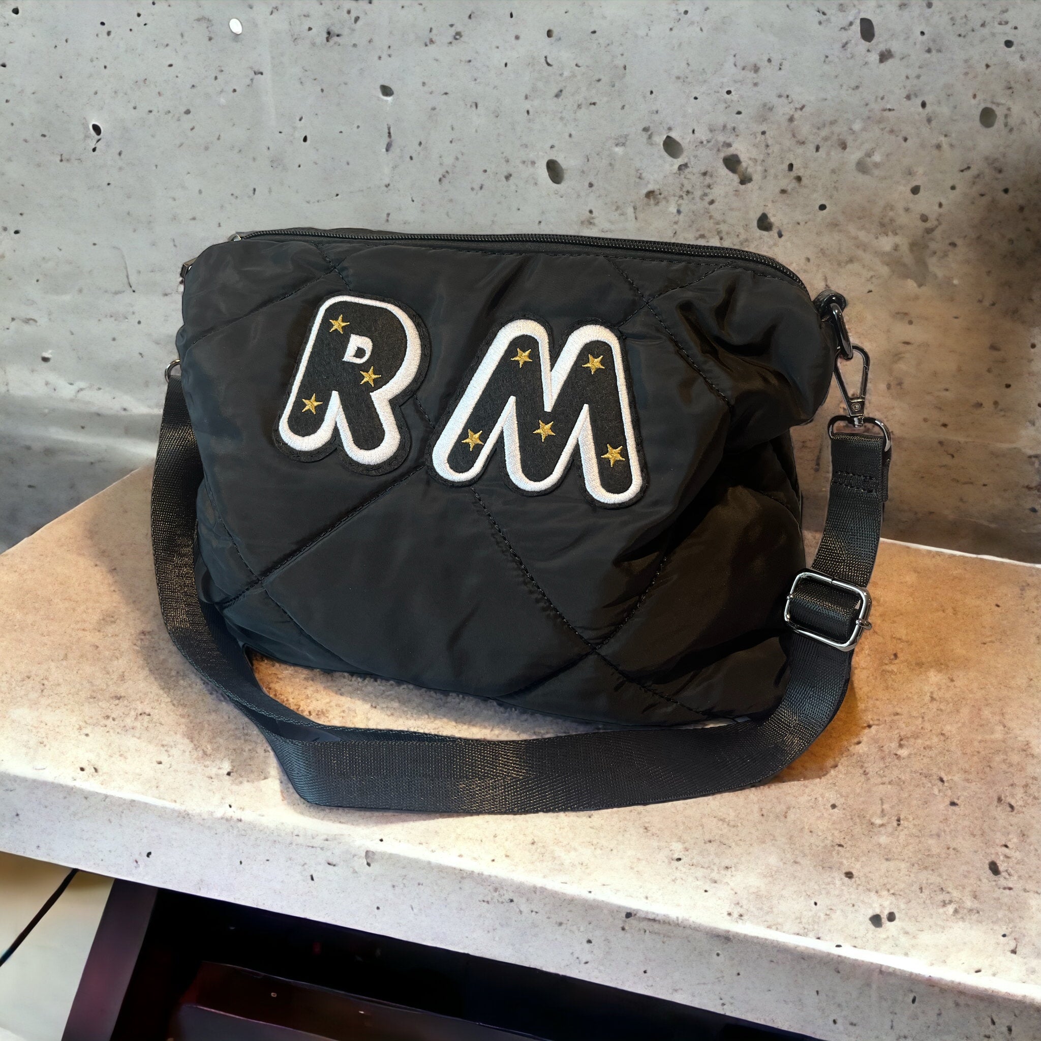 Black quilted messenger bag