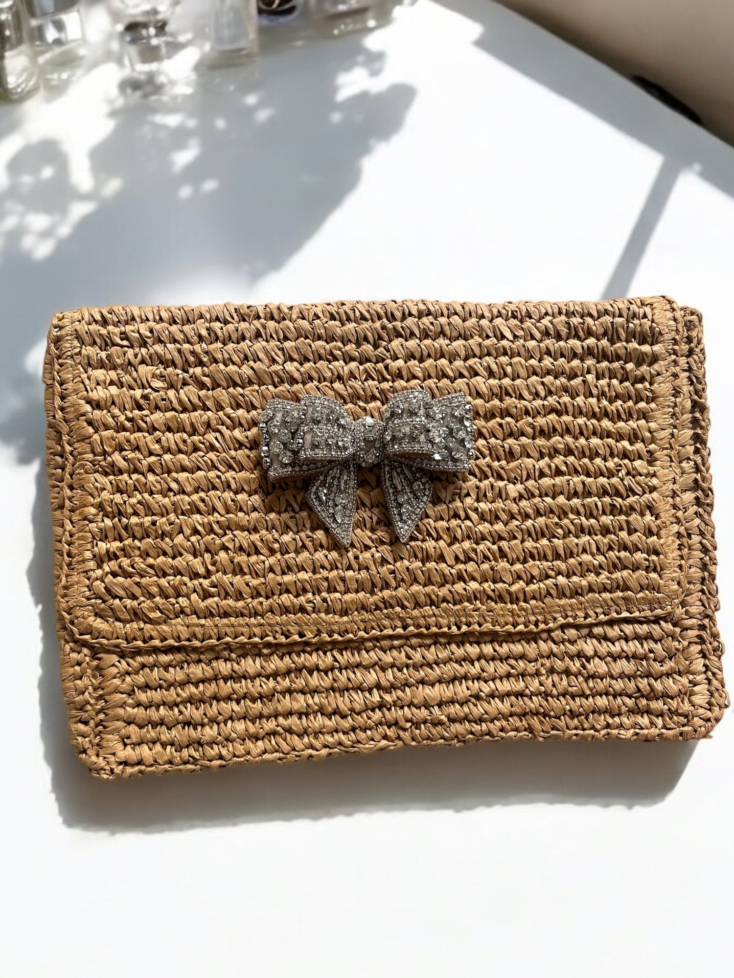 Straw clutch bag with bow detail