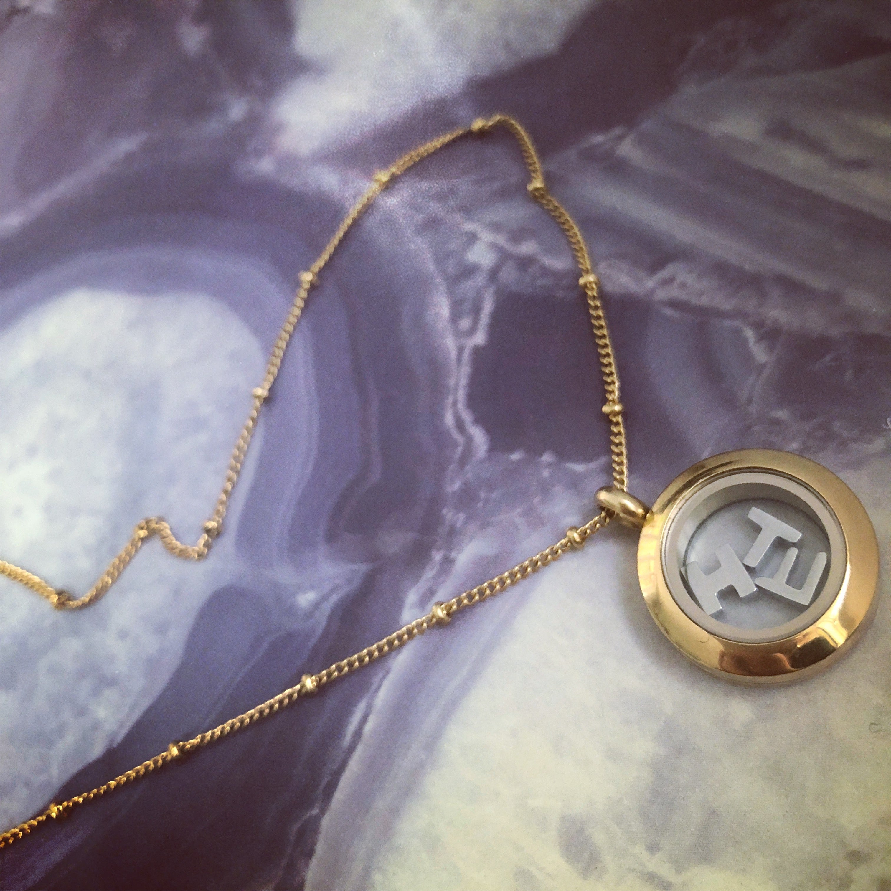 Tiny gold locket necklace