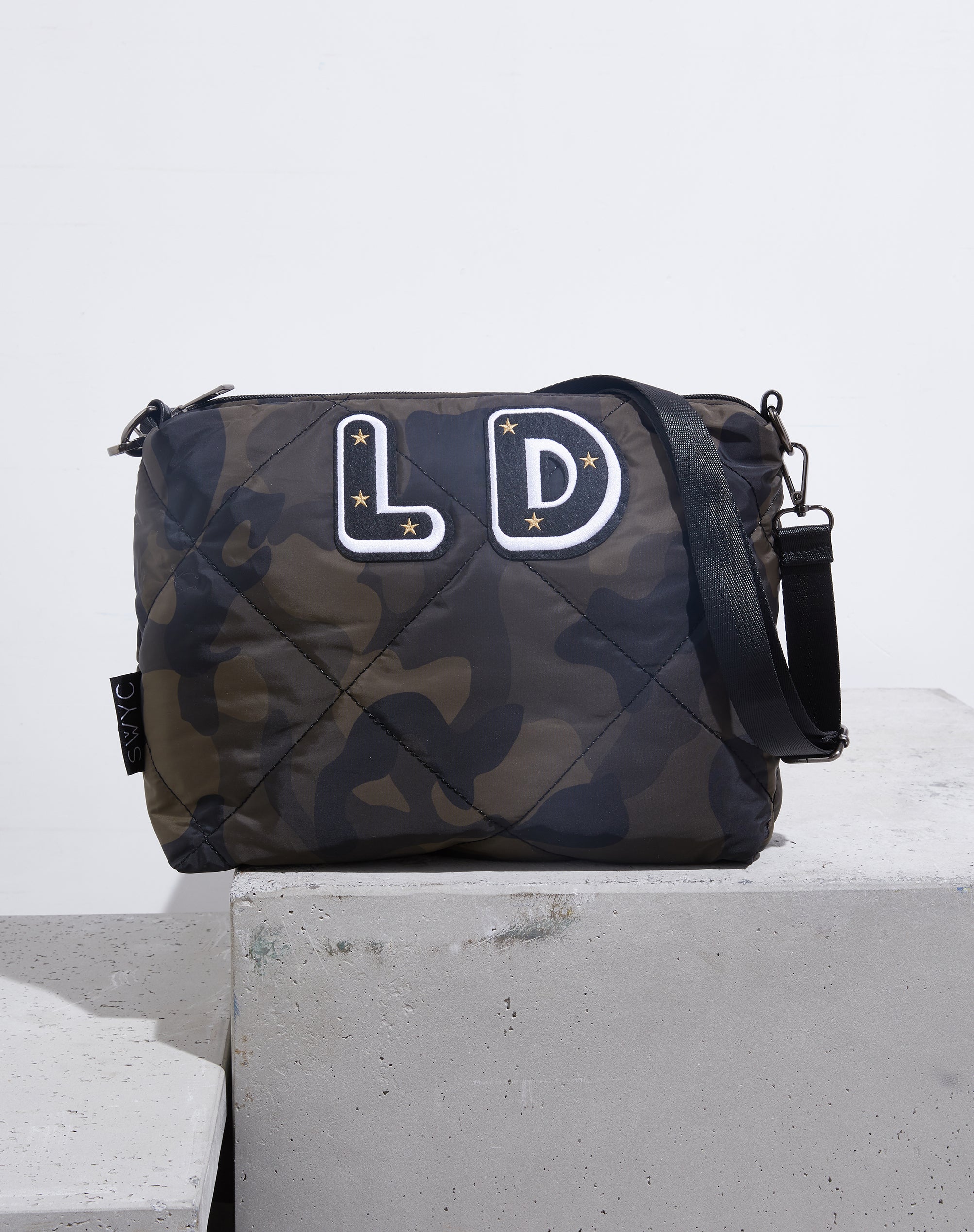 Camo print quilted messenger bag