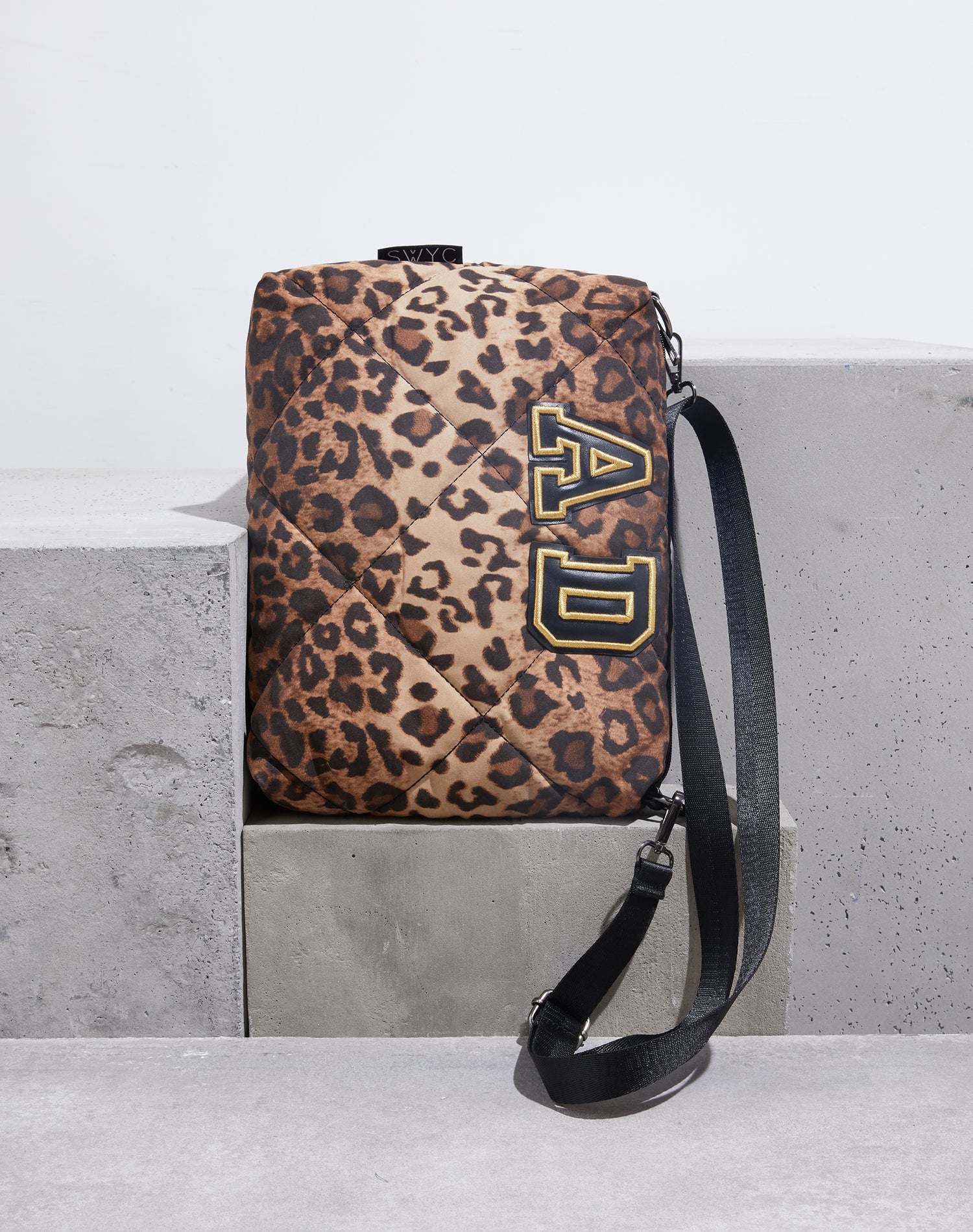 Leopard print quilted messenger bag